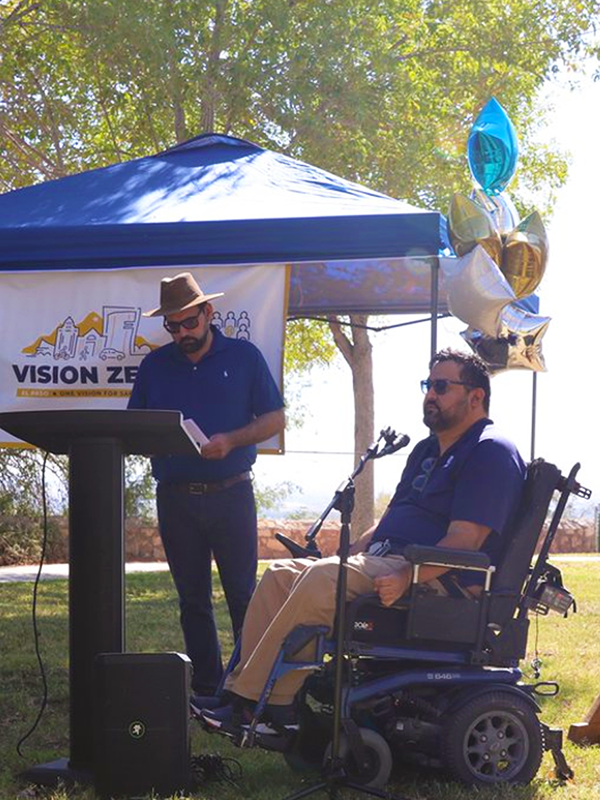 Collaborating for Safer Solutions Header - post - apr2025 Person in electric mobility chair speaks at a Vision Zero public event