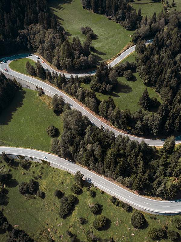 The Road Less Traveled Header - post - apr2025 Photo of a road winding through the hills with minimal traffic