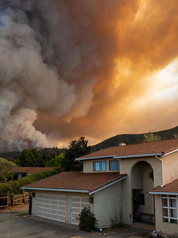 The California "River Fire" of Salinas, in Monterey County, was Residential home with nearby wildfire burning in the background