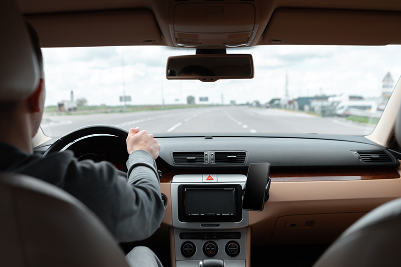 The man driving the modern car