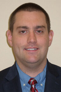 headshot of Claude Strayer