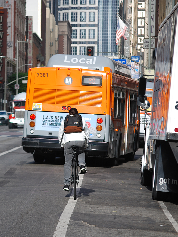 Woman lifting bicycle into a train as she boards