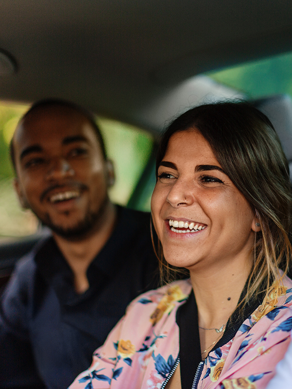CincinnatiUber Header - Post - July2020 Woman lifting bicycle into a train as she boards