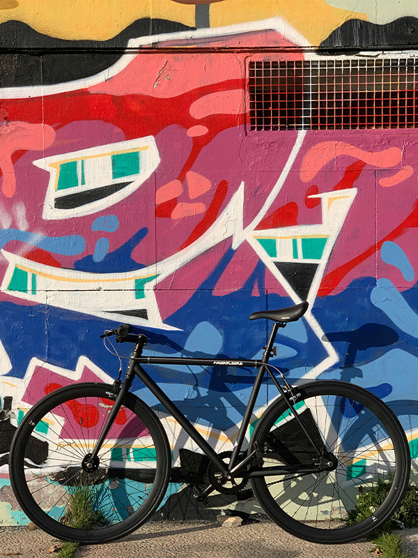 Header Image - Equity and Infrastructure Improvements - Post - May2022 Bicycle in front of art wall