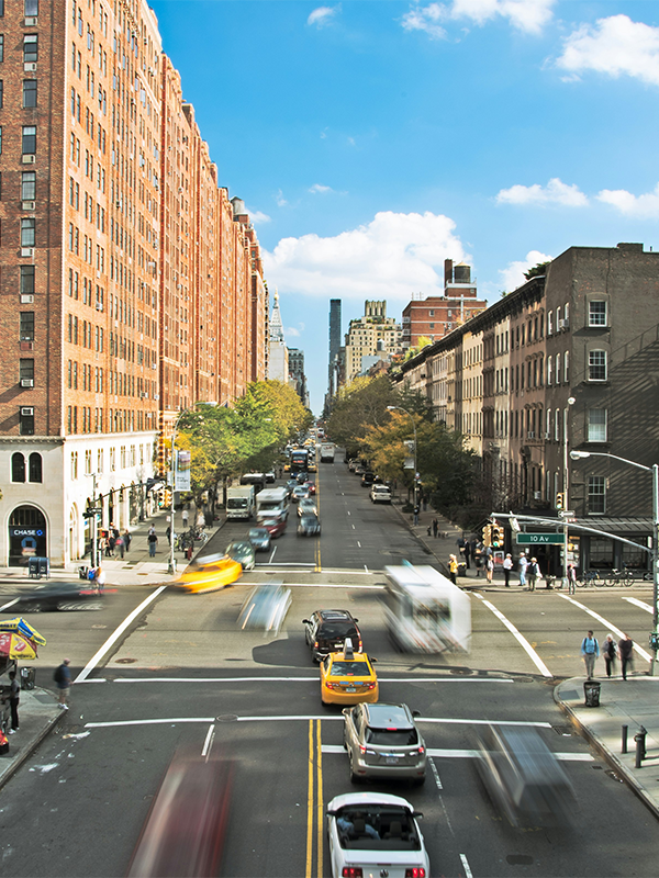 Header Image - Quantifying VMT Reduction - Post - Aug2022 cars and people in a busy intersection