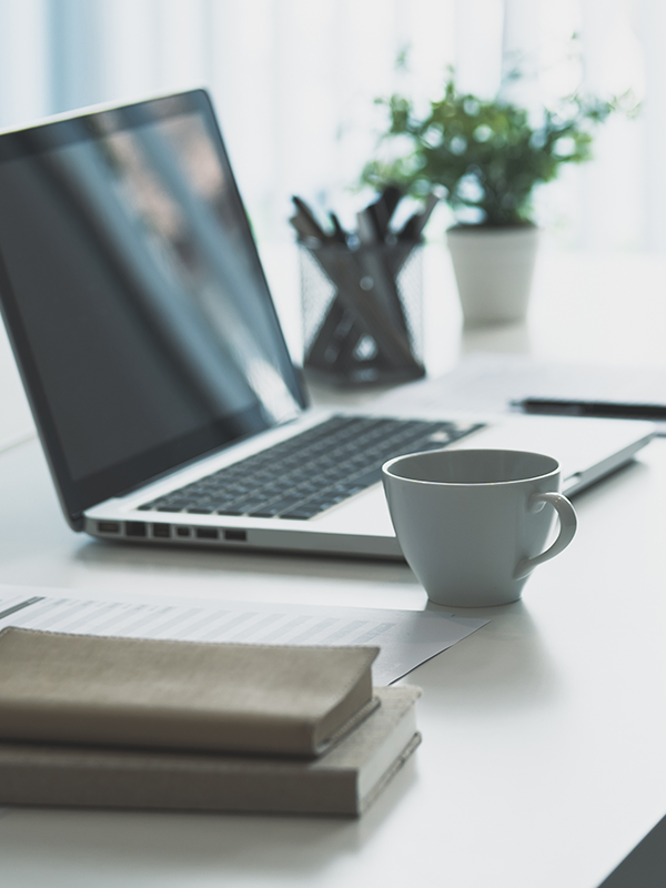Telework Header - post - Nov2022 Photo of work desk with computer and coffee cup