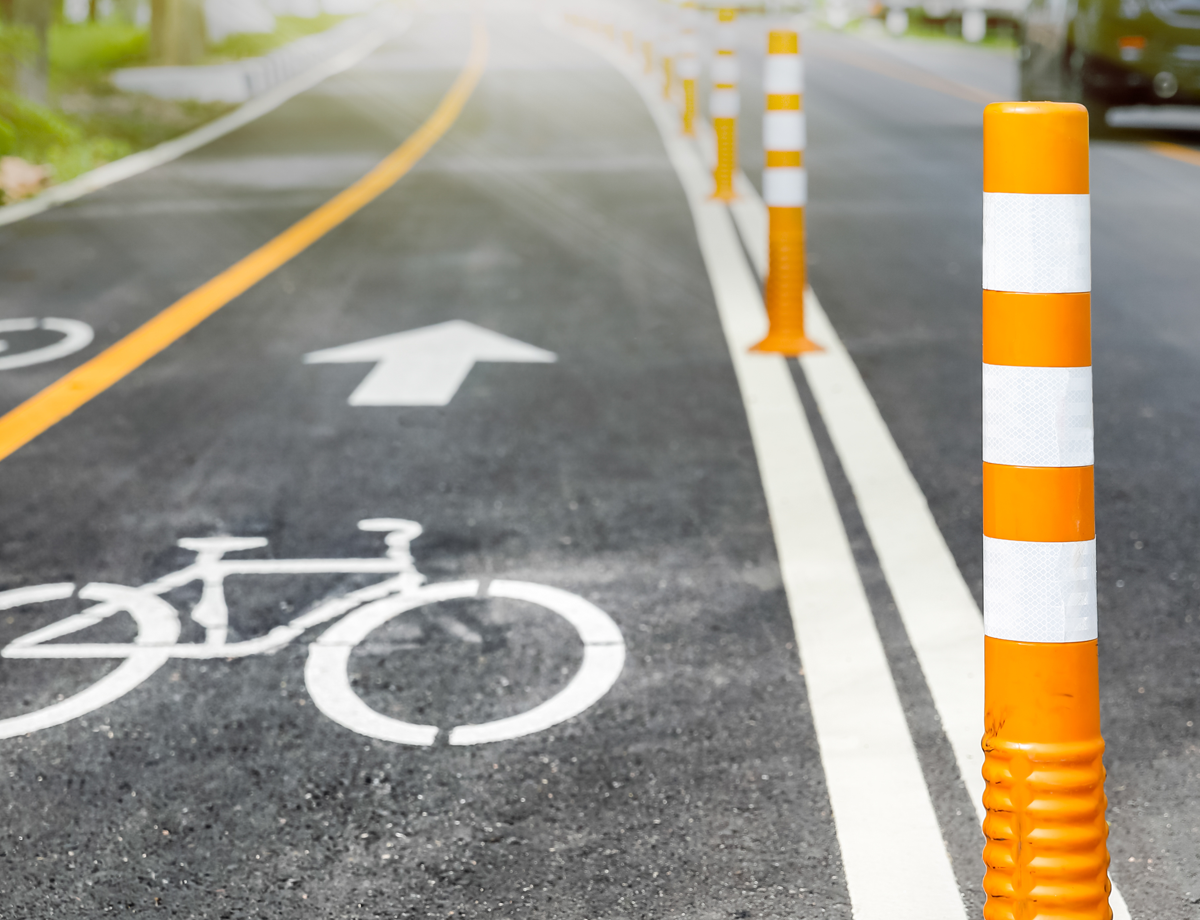 Orange bollards marking a bike lane on a road
