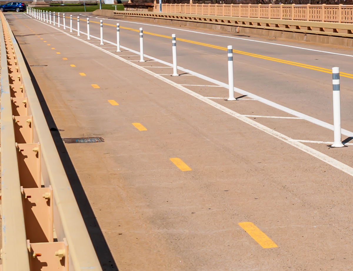 Bike lane with bollards on a bridge on a sunny day