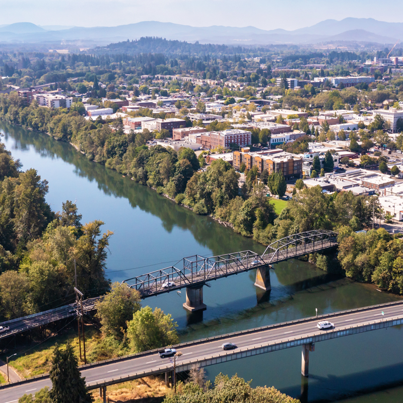 Aerial view of cars driving into the city