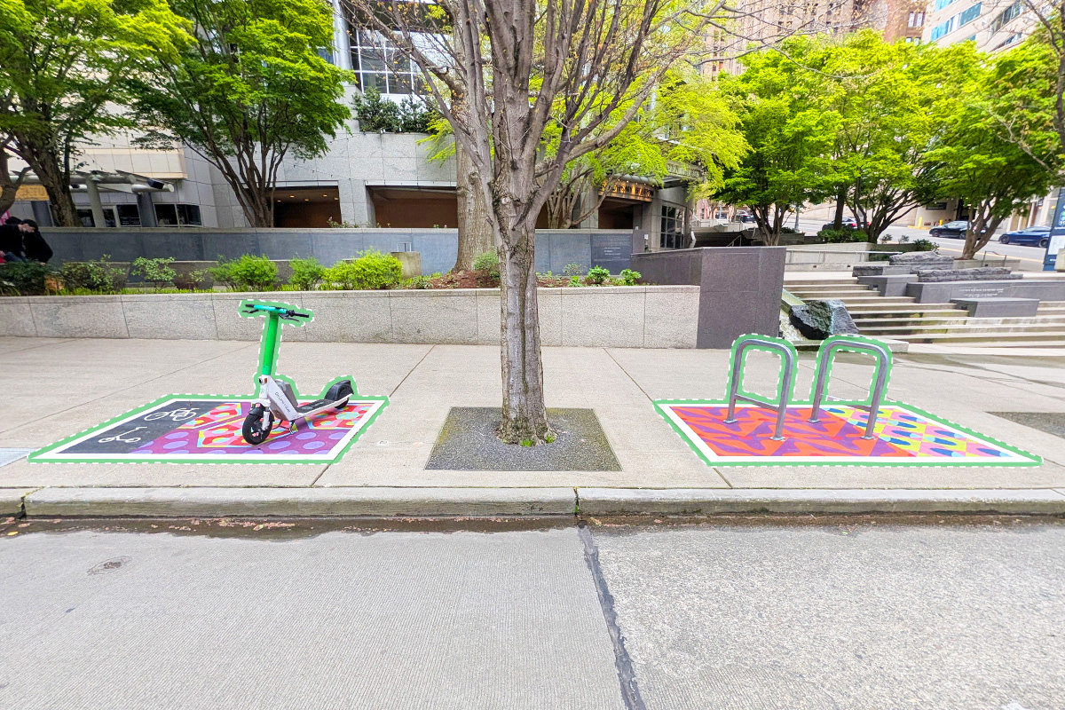 An example of the parking corrals in use with local mural art painted within the contained space.